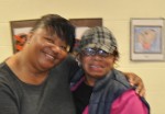 Author Sherri Winston gets a hug from former her former English teacher during a November 2012 visit to the Muskegon Heights Library in Muskegon Heights, Mich.